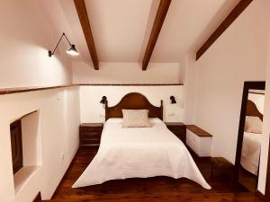 a bedroom with a bed with a white bedspread at Villa Revolcona in La Adrada