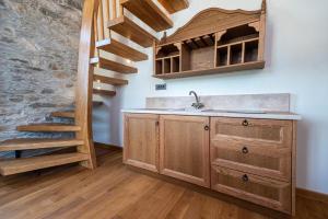 a kitchen with a sink and a staircase at Nostos Country House in Tsagarada +144 photos