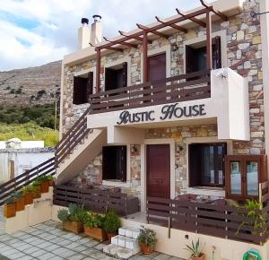 ÉmbonasRustic House的带有音乐厅标志的建筑