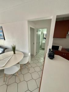 a kitchen with a table and chairs in a room at Apartamento Atlantico - Vista Mar in Monte Gordo