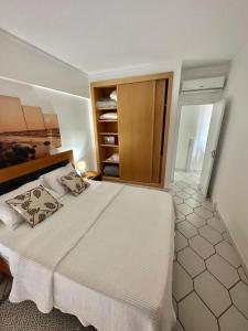 1 dormitorio con 1 cama blanca grande en una habitación en Apartamento Atlantico - Vista Mar, en Monte Gordo