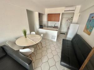 a living room with a table and a kitchen at Apartamento Atlantico - Vista Mar in Monte Gordo