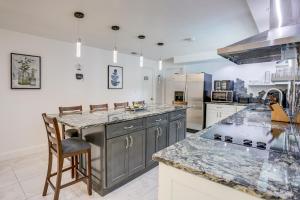 a kitchen with granite counter tops and a large island at Largo Family Oasis Private Pool and Hot Tub! in Largo