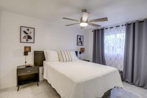 a bedroom with a white bed and a ceiling fan at Largo Family Oasis Private Pool and Hot Tub! in Largo +24 photos