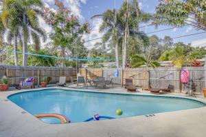 a swimming pool in a yard with a fence and trees at Largo Family Oasis Private Pool and Hot Tub! in Largo