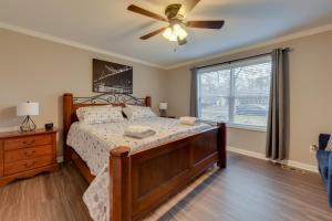 a bedroom with a bed and a ceiling fan at Family-Friendly Home with Deck Near Colonial Beach! in Colonial Beach