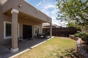 a house with a patio with a table in the yard at 4 bedroom gorgeous home Eastside El Paso in El Paso