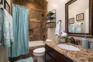 a bathroom with a sink and a toilet and a tub at 4 bedroom gorgeous home Eastside El Paso in El Paso +27 photos