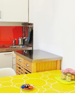 a kitchen with a table with a yellow floor at London SW Holiday Apartment - Free parking in London