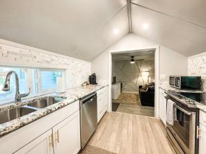 a kitchen with a sink and a microwave at Cozy cottage in the heart of COS - pet friendly in Colorado Springs