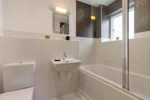 a bathroom with a toilet and a sink and a bath tub at Reflections HM77 HOT TUB Lakeside Spa NEW in Somerford Keynes +46 photos
