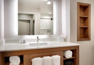 a bathroom with a sink and a mirror and towels at Residence Inn by Marriott Vail in Vail