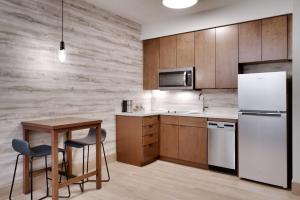 a kitchen with a white refrigerator and a table at Residence Inn by Marriott Vail in Vail