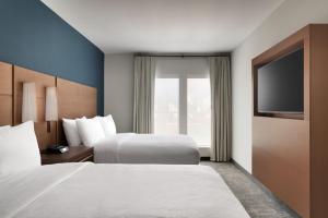 a hotel room with two beds and a flat screen tv at Residence Inn by Marriott Vail in Vail