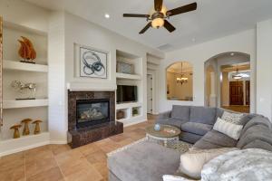 a living room with a couch and a fireplace at Spacious North Phoenix Oasis with Pool and Patio! in Phoenix