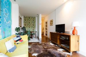 里斯本的住宿－普林西比皇家棕櫚樹屋中央公寓，带沙发和电视的客厅