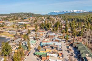 an aerial view of a town with snow covered mountains at Experience Montana Cabins - Bear's Den #4 in Bigfork