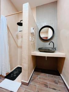 a bathroom with a sink and a mirror at Arena Apartment 2 in Holbox Island