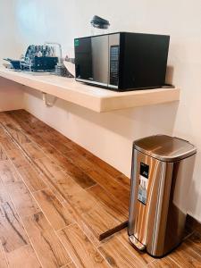a microwave sitting on a counter next to a trash can at Arena Apartment 1 in Holbox Island +9 photos