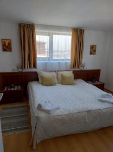 a bedroom with a bed with two towels on it at Gondola lift apartment 5401 in Bansko