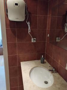 a bathroom with a sink and a blow dryer on the wall at Gondola lift apartment 5401 in Bansko