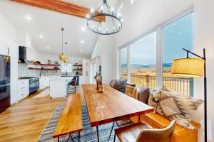 a kitchen and living room with a wooden table at Mountain Sky in Granby