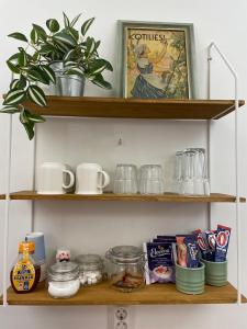 a shelf with food and other items on it at Puuppola Kotikoivu 