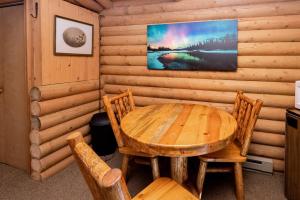 a dining room with a wooden table and chairs at Experience Montana Cabins - Birdsong #2 in Bigfork