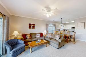 a living room with a couch and a dining room at Cypress Bay 14-204 in Little River