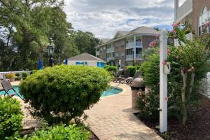 a courtyard with a pool in a apartment complex at Cypress Bay 14-204 in Little River