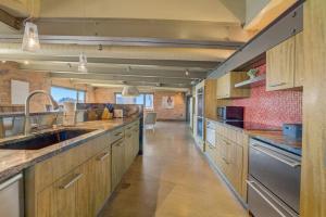 a large kitchen with wooden cabinets and stainless steel appliances at 1600 KCM Penthouse Apartment in Cleveland