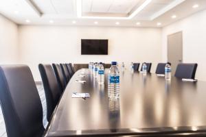 a conference room with a long table with bottles of water at Holiday Inn Express Toronto-North York, an IHG Hotel in Toronto