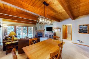 a dining room and living room with a wooden table at Riverside A02 - Riverside Chickadee in Telluride