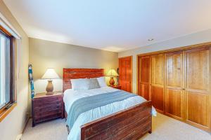 a bedroom with a large bed and wooden cabinets at Riverside A02 - Riverside Chickadee in Telluride