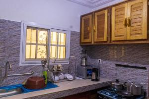 a kitchen counter with a sink and a window at E&T Resorts in Buea