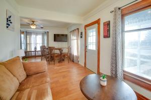 a living room with a couch and a table at Historic Farnam Home Near Three Brothers Vineyard! 