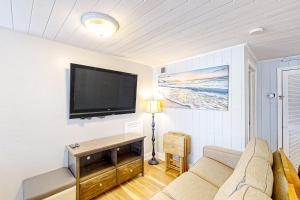 a living room with a couch and a flat screen tv at Seahorse Serenity in Myrtle Beach