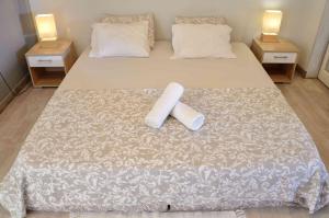 a bed with a white bedspread with a pillow on it at Ria Terrace Apartment III in Faro