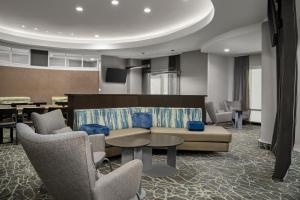 a lobby with a couch and chairs and a table at SpringHill Suites by Marriott Annapolis in Annapolis