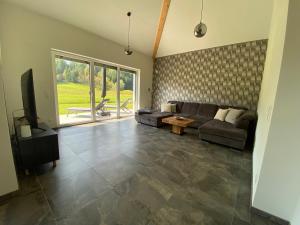 a living room with a couch and a tv at Ferienhaus BUK in Hermagor