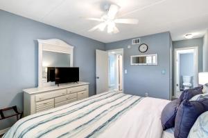 a bedroom with a bed and a ceiling fan at 112 Oceans Of Amelia in Amelia Island