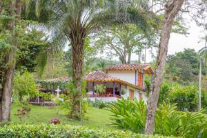 ein Haus inmitten eines Gartens mit Bäumen in der Unterkunft El Remanso Complejo Ecoturistico 