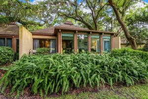 a house with a bunch of plants in front of it at 3325 Fairway Oaks in Amelia Island