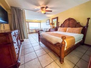 a bedroom with a large bed and a ceiling fan at Aqua Beach Hotel in Wildwood Crest