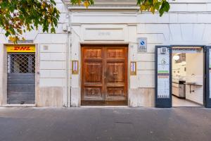 a building with a wooden door on a street at TRASTEVERE SUITE EXPERIENCE in Rome