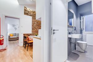 a bathroom with a sink and a toilet in a room at TRASTEVERE SUITE EXPERIENCE in Rome