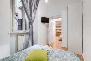 a small bedroom with a bed and a window at TRASTEVERE SUITE EXPERIENCE in Rome