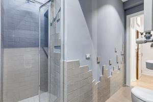 a bathroom with a shower and a toilet at TRASTEVERE SUITE EXPERIENCE in Rome