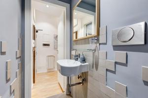 a bathroom with a sink and a mirror at TRASTEVERE SUITE EXPERIENCE in Rome +27 photos