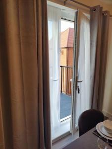 een open raam met uitzicht op een balkon bij 2 bedroom en-suite apartment in Basildon, Essex (Enjoy the simple things in life) in Laindon